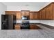 Kitchen with dark wood cabinets and granite countertops at 7305 Rockhouse Rd, Austell, GA 30168