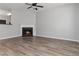 Living room with fireplace, hardwood floors, and ample space for furniture at 7305 Rockhouse Rd, Austell, GA 30168