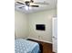 Bedroom with wood floors, a ceiling fan, and mounted TV at 870 Mayson Turner Rd # 1326, Atlanta, GA 30314