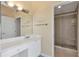 Bright bathroom with stone tiled shower, vanity, and mirrored wall at 3475 Oak Valley Ne Rd # 1930, Atlanta, GA 30326