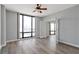 Bright bedroom features hardwood floors, ceiling fan, and large windows with city views at 3475 Oak Valley Ne Rd # 1930, Atlanta, GA 30326