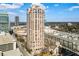 A high-rise residential building stands tall in this exterior daytime shot with lots of other buildings surrounding it at 3475 Oak Valley Ne Rd # 1930, Atlanta, GA 30326