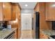Galley kitchen boasting wood cabinets, granite countertops, and stainless steel appliances at 3475 Oak Valley Ne Rd # 1930, Atlanta, GA 30326