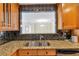 View of living space through passthrough from kitchen with granite counters and wood cabinets at 3475 Oak Valley Ne Rd # 1930, Atlanta, GA 30326