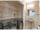 Laundry room with washer, dryer, storage shelves and sink with pedestal at 3475 Oak Valley Ne Rd # 1930, Atlanta, GA 30326