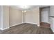 Living area with gray flooring, tan walls and white trim along the floor and ceiling at 3475 Oak Valley Ne Rd # 1930, Atlanta, GA 30326