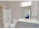 Clean bathroom featuring a shower-tub combo, toilet, and vanity with a large mirror at 3000 Smyrna Grove Dr, Smyrna, GA 30082