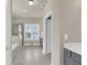 Bathroom view with tiled flooring, glass enclosed shower, soaking tub, gray cabinetry and white countertop at 3000 Smyrna Grove Dr, Smyrna, GA 30082