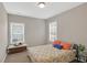 Cozy bedroom featuring neutral walls, carpet, and a floral-patterned bedspread at 3000 Smyrna Grove Dr, Smyrna, GA 30082
