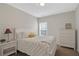 Cozy bedroom with a well-made bed, a white dresser, and a small nightstand at 3000 Smyrna Grove Dr, Smyrna, GA 30082