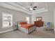 Relaxing bedroom with tray ceiling, ceiling fan, dresser, and plenty of natural light at 3000 Smyrna Grove Dr, Smyrna, GA 30082