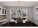 Bright dining room with large windows, chandelier and integrated serving area at 3000 Smyrna Grove Dr, Smyrna, GA 30082