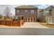 The rear exterior of the house shows a garage, covered porch, and a stained wood fence around the property at 3000 Smyrna Grove Dr, Smyrna, GA 30082