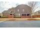The back exterior of the house with a covered porch. The property is surrounded by a wooden fence at 3000 Smyrna Grove Dr, Smyrna, GA 30082