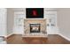 Charming stone fireplace with built-in bookshelves, creating a cozy focal point in the living room at 3000 Smyrna Grove Dr, Smyrna, GA 30082
