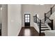 Elegant foyer with hardwood floors, staircase, and a stylish front door, creating a welcoming entrance at 3000 Smyrna Grove Dr, Smyrna, GA 30082