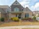 Charming two-story home featuring a well-manicured lawn, brick accents, and a welcoming front porch at 3000 Smyrna Grove Dr, Smyrna, GA 30082