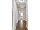 Hallway with hardwood floors and several doors, offering access to various rooms in the home at 3000 Smyrna Grove Dr, Smyrna, GA 30082