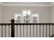 Interior view showcasing a staircase railing, a decorative light fixture, and bright windows at 3000 Smyrna Grove Dr, Smyrna, GA 30082