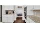 Eat-in kitchen area with granite countertops, white cabinets, stainless appliances and a mud room at 3000 Smyrna Grove Dr, Smyrna, GA 30082