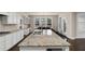 Large open concept kitchen and dining area with granite countertops, white cabinets, and stainless steel appliances at 3000 Smyrna Grove Dr, Smyrna, GA 30082
