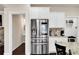 Spacious kitchen area with stainless steel refrigerator and white cabinets, open to other rooms at 3000 Smyrna Grove Dr, Smyrna, GA 30082