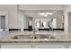 Close-up of kitchen island featuring a stainless steel double sink and granite countertops at 3000 Smyrna Grove Dr, Smyrna, GA 30082