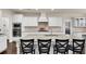 A kitchen with a large island, granite countertops, white cabinets, and stainless steel appliances at 3000 Smyrna Grove Dr, Smyrna, GA 30082