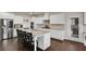 Modern kitchen with stainless steel refrigerator, granite counters, white cabinets and eat-in kitchen island at 3000 Smyrna Grove Dr, Smyrna, GA 30082