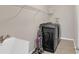 Functional laundry room with a modern washer and dryer set, utility sink, and shelving at 3000 Smyrna Grove Dr, Smyrna, GA 30082
