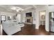 Spacious living room with a coffered ceiling, stone fireplace, and an adjacent powder room for convenience at 3000 Smyrna Grove Dr, Smyrna, GA 30082