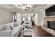 Open-concept living room with a coffered ceiling, stone fireplace, and hardwood floors, creating a warm ambiance at 3000 Smyrna Grove Dr, Smyrna, GA 30082