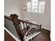 Bright staircase with dark wood stairs, black iron railings, and lots of natural light from the transom windows at 3000 Smyrna Grove Dr, Smyrna, GA 30082