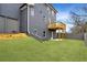 Large backyard with a patio, a balcony, green grass, and a privacy fence at 386 10Th Unit 57 St, Auburn, GA 30011