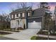 Charming two-story home with a well-manicured lawn, a driveway, and an attached two-car garage at 386 10Th Unit 57 St, Auburn, GA 30011