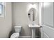 Small powder room with pedestal sink and oval mirror at 386 10Th Unit 57 St, Auburn, GA 30011