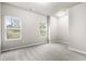 Bright bedroom with carpet and two windows at 386 10Th Unit 57 St, Auburn, GA 30011
