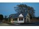 White cottage with metal roof and black windows at dusk at 386 10Th Unit 57 St, Auburn, GA 30011