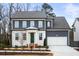 Two-story house featuring gray siding, white accents, and a green front door at 386 10Th Unit 57 St, Auburn, GA 30011