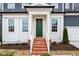 Brick steps leading to a charming green front door with white columns at 386 10Th Unit 57 St, Auburn, GA 30011