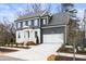 Two-story gray house with white garage door at 386 10Th Unit 57 St, Auburn, GA 30011