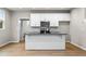 Modern kitchen with white cabinets, large island, and stainless steel appliances at 386 10Th Unit 57 St, Auburn, GA 30011