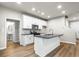 Open kitchen features white cabinets, kitchen island, and stainless steel appliances at 386 10Th Unit 57 St, Auburn, GA 30011
