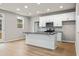 Modern kitchen with white cabinets, a large island, and stainless steel appliances at 386 10Th Unit 57 St, Auburn, GA 30011