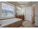 Main bathroom with soaking tub, vanity and separate shower at 4824 Archer Pl, Acworth, GA 30101
