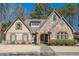 Curb appeal abounds at this charming two-story home showcasing stone accents and a manicured lawn at 4824 Archer Pl, Acworth, GA 30101