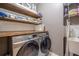 Laundry room with washer, dryer and wooden shelves at 4824 Archer Pl, Acworth, GA 30101