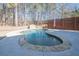 Kidney-shaped pool with stone coping and wooden privacy screen at 4824 Archer Pl, Acworth, GA 30101