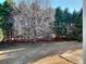 View of backyard with large tree and fence at 1070 Blackwood Ct, Johns Creek, GA 30024