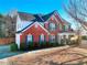 Brick two-story house with a covered porch and landscaped yard at 1070 Blackwood Ct, Johns Creek, GA 30024